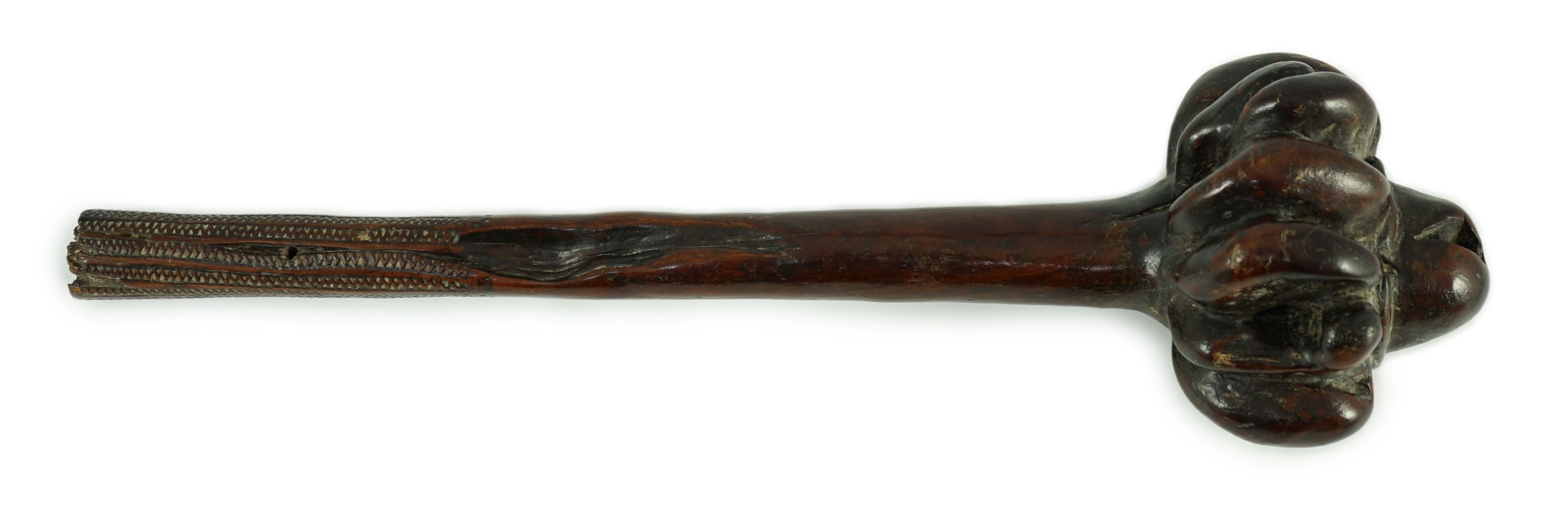 A Fijian hardwood throwing club, with zig-zag relief carved handle and further irregular spotted decoration, 40cm long